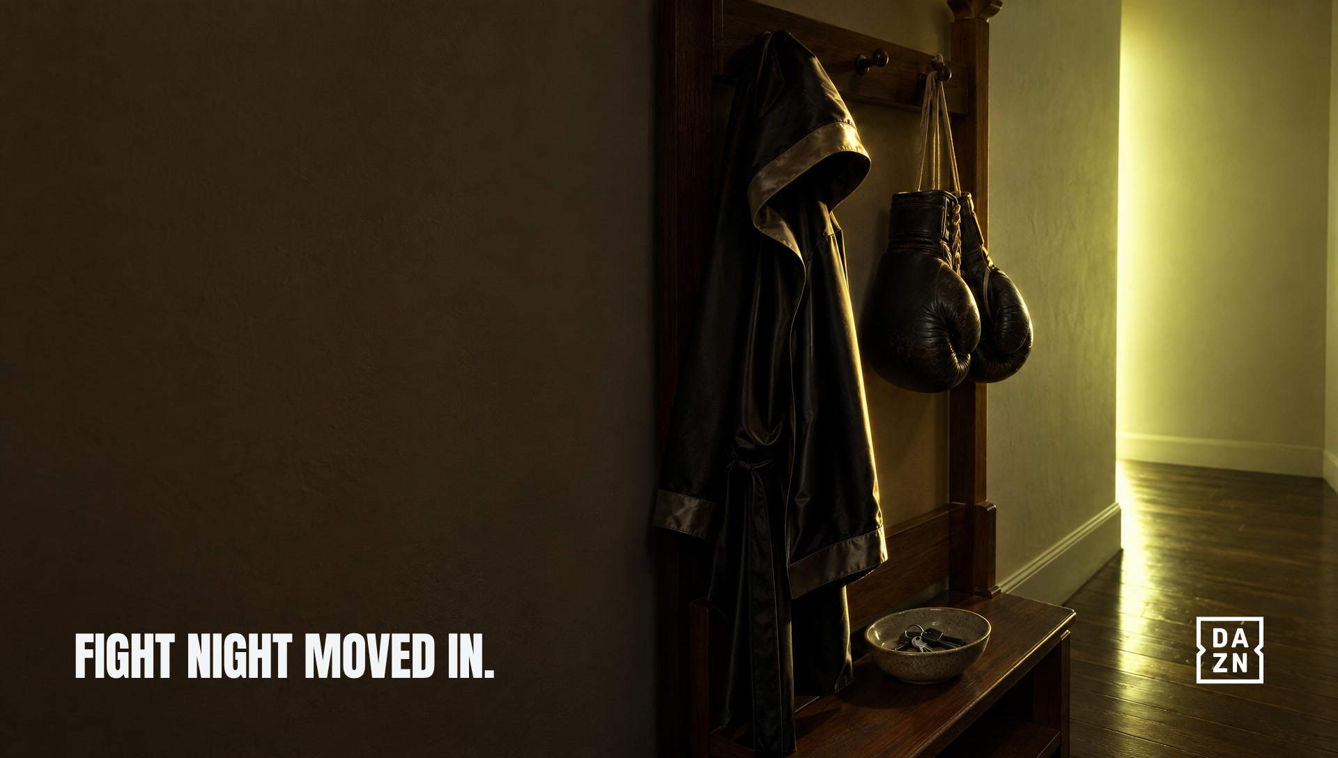 A boxing robe and gloves on a hallway coat rack